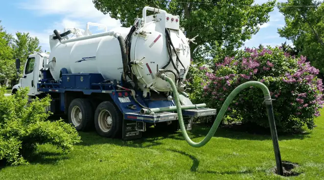 Professional vacuum truck performing residential drainage and septic maintenance in Savannah, GA