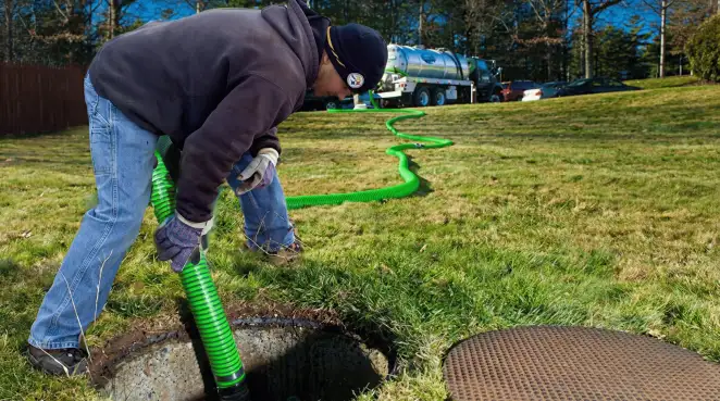 Service technician performing residential septic pumping and drainage maintenance in Savannah, GA
